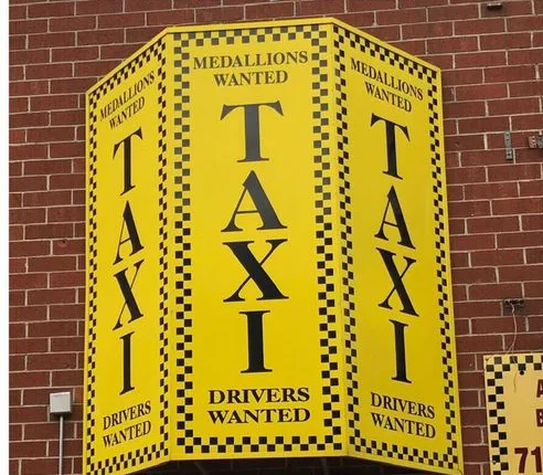 Before: yellow taxi sign